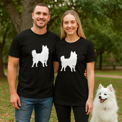 Man and woman wearing black t-shirts with white dog silhouettes in a park setting.